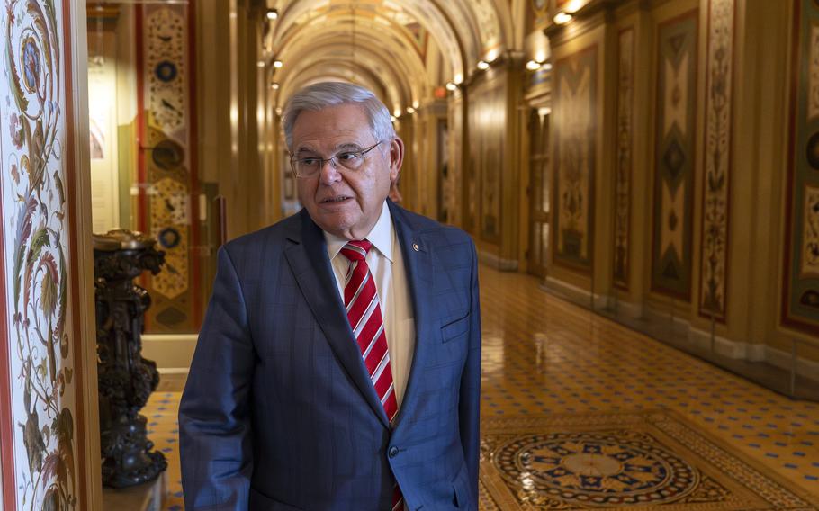 Sen. Bob Menendez in the left half of the foreground of an image, in the halls of Congress.