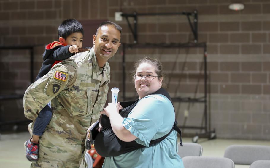 Alaska Army Guard Spc. Joseph Whitefeather, an infantryman with Bravo Company, 1st Battalion, 297th Infantry Regiment, reunites with his family during a welcome home event at the Alaska National Guard Readiness Center on Joint Base Elmendorf-Richardson, Aug. 10, 2024. 