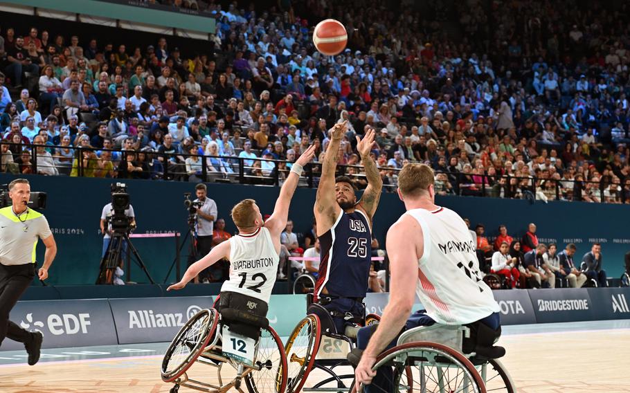 Jorge Salazar, a Marine Corps veteran, shoots over Great Britain's Gregg Warburton in the wheelchair basketball championship game  at the 2024 Paris Paralympics, Sept. 7, 2024. The U.S. took the gold with a 73-69 win.