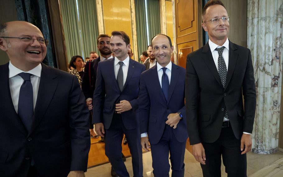 Parviz Shahbazov, Sebastian Burduja, Levan Davitashvili and Peter Szijjarto smile after a meeting 