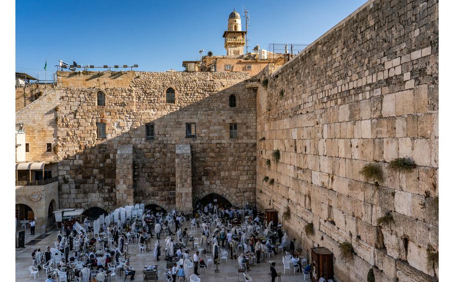 Jewish worshippers pray at the Western Wall in the Old City of Jerusalem in August 2021. 