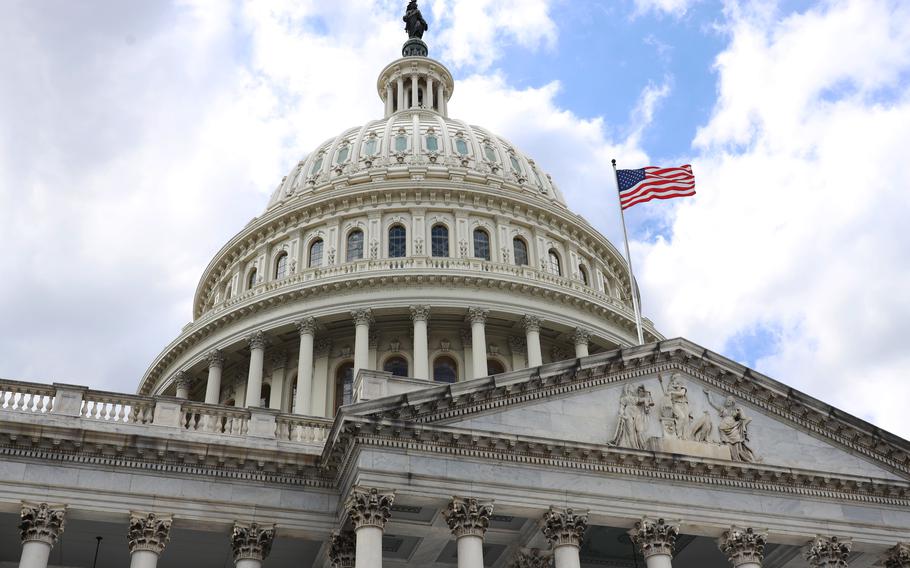 The American flag flies on the right side of the U.S. Capitol building rotunda.