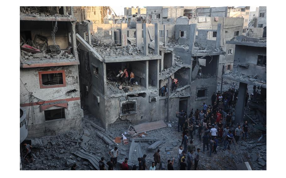 Palestinians inspect the damage caused by an Israeli strike on a house in Khan Younis, in southern Gaza, on Thursday, Oct. 19, 2023.