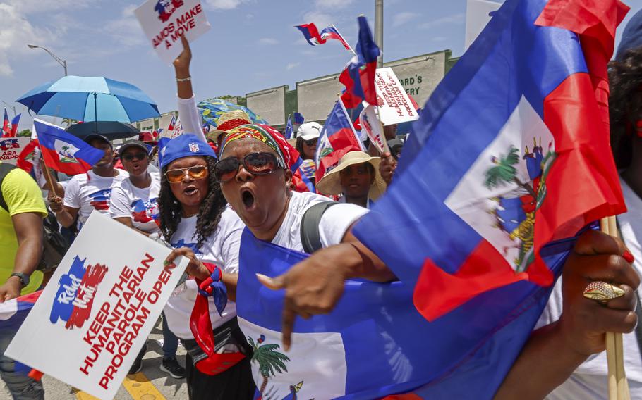 Marchers wave flags and chant words of support as residents, and members of the South Florida Haitian community joined Haitians across the United States and the world while marching towards City Hall from North Miami High School on July 9, 2023, to demand “Relief for Haiti.”