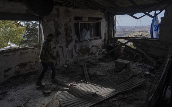 Igor Abramovich surveys heavy damage to a house from the 14-month war between Hezbollah and Israel  in Kibbutz Manara, on the border with Lebanon, northern Israel, Jan. 5, 2025. (AP Photo/Ariel Schalit)