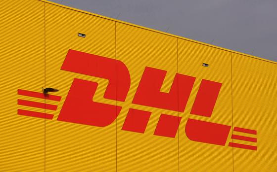 FILE - The logo of German fright company DHL is covered on a terminal at the airport Leipzig/Halle, Jan. 29, 2008. (AP Photo/Matthias Rietschel, File)