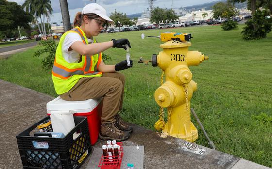 A Navy contractor collects water samples Jan. 31, 2024, as part of a long-term drinking water monitoring program at Joint Base Pearl Harbor-Hickam, Hawaii.