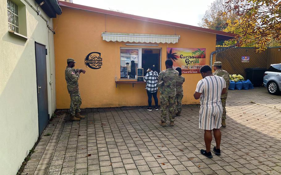 People stand in line to order Caribbean food in Bavaria.