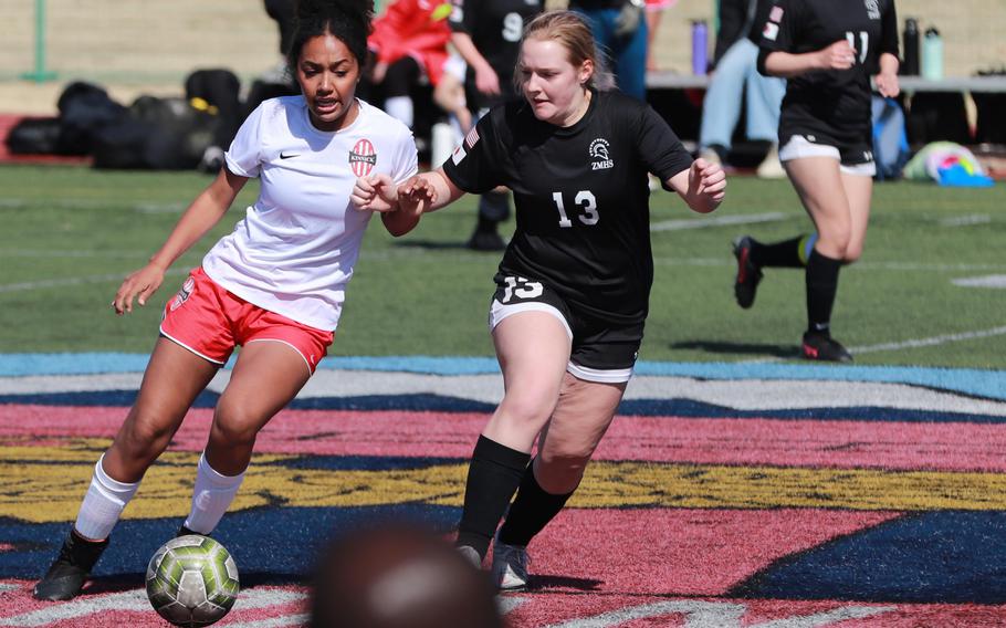 Nile C. Kinnick's Alyssa Staples dribbles against Zama American's Lia Thompson during Saturday's DODEA-Japan girls soccer match. The Red Devils won 6-0.