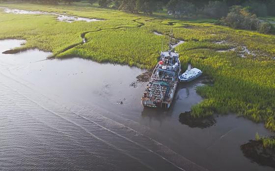 A video screen grab shows two vessels, one of which is a 120-foot-long former Navy mine sweeper, parked on Bohicket Creek, S.C.