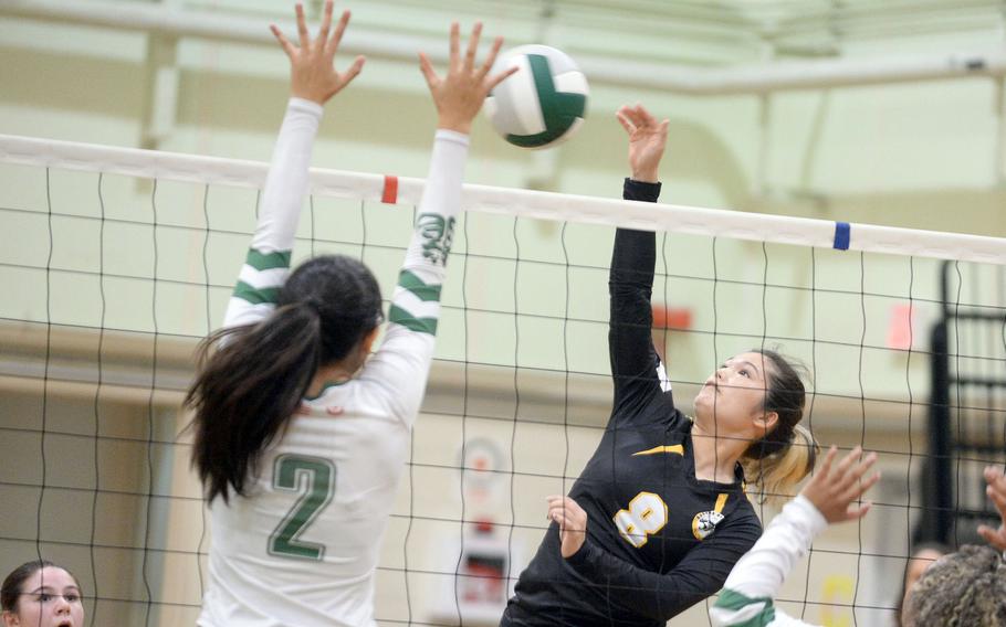 Kadena's Lia Connolly spikes against Kubasaki's Runa Holladay during Tuesday's Okinawa volleyball match. The Dragons won in four sets.