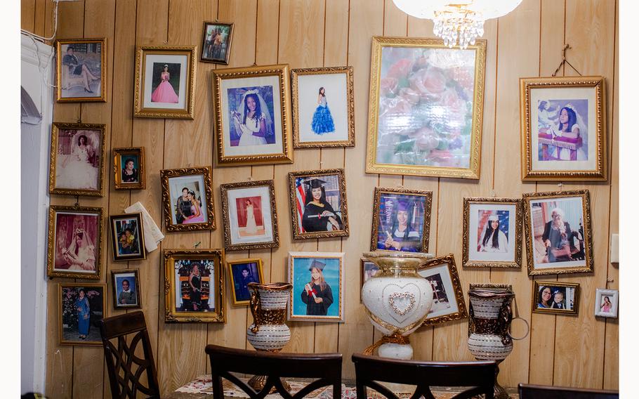 A wall of family portraits in the living room of the home Jose Marquez shares with his mother. 