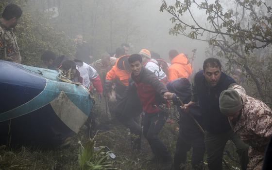 FILE - In this photo provided by Moj News Agency, rescue team members work at the scene of a crash of a helicopter carrying Iranian President Ebrahim Raisi in Varzaghan in northwestern Iran, Monday, May 20, 2024.  (Azin Haghighi, Moj News Agency via AP, File)