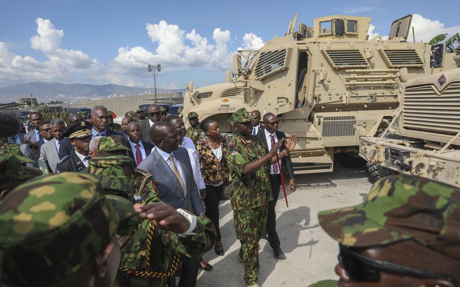 Kenya's President William Ruto, center left, visits Kenyan police, part of a UN-backed multinational force, at their base in Port-au-Prince, Haiti, Saturday, Sept. 21, 2024.