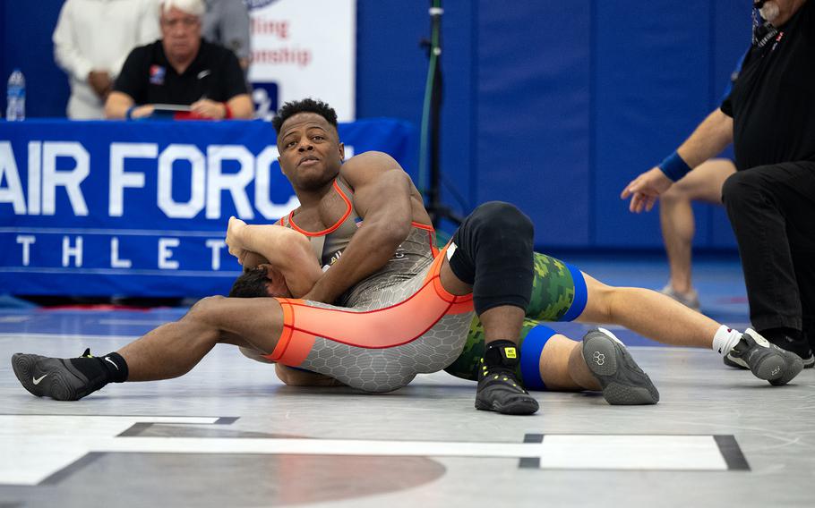 Army Spc. Kamal Bey pins Air Force Senior Airman Samuel Adams during the Greco-Roman style wrestling portion of  the 2024 Armed Forces Wrestling Championship in Colorado Springs, Colo. March 2, 2024. Bey will be competing in the 2024 Paris Olympics.