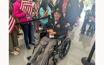 World War II veteran Art Leach, a Navy flyer who served in air combat on the USS Yorktown, arrives for a sendoff ceremony at Dallas-Fort Worth, Texas, on Friday, May 31, 2024.