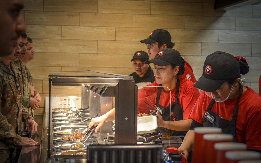 Panda Express employees serve customers on grand-opening day at Camp Humphreys.