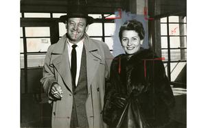 Haneda Tokyo International Airport, Japan, March 30, 1958: Actor William Holden is all smiles on this photo print, despite being ruthlessly cut in favor of his wife, actress Brenda Marshall. 

The red marks indicate crop and edits to be made in the composition room so only the desired part of the photograph is published in the newspaper. In this case, the editors were not interested in Holden, but wanted only his wife, hence the big X through the actor's face. 
The background of Brenda Marshall is greyed out to appear uniform when printed as her photo would run only as a portrait of her face in the paper. 

When digitizing photo prints from our Pacific Stars and Stripes archives, we scan every image twice. Once in color with all the crop and edit marks present and visible. The second scan is a B&W scan after archives' staff have carefully removed the red edit marks. 

As the vast majority of pre-1964 Stars and Stripes Pacific negatives and slides were unwittingly destroyed by poor temporary storage in 1963, the prints developed from the late 1940s through 1963 are the only images left of Stripes' news photography from those decades – with the exception the negatives of some 190 pre-1964 photo assignment found recently. Stars and Stripes' archives team is scanning these prints and negatives to ensure the preservation of the images captured. 

META TAGS: Archives Month; preservation; news archives; newspaper archives;  Adris Ankerson; Pacific; entertainment; celebrity; actor; actress; 