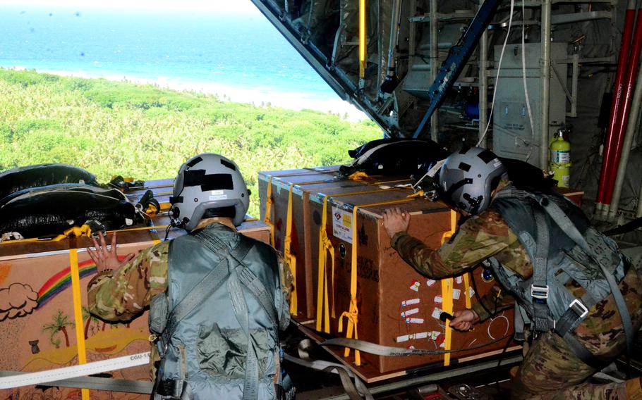 Airmen prepare to drop supplies to a remote island.