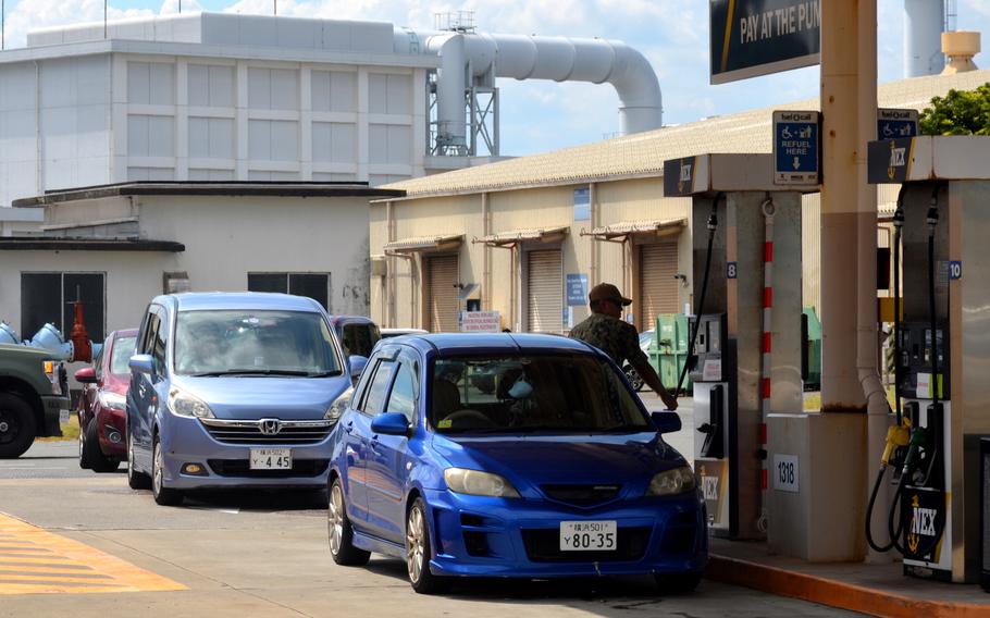 Sailors and civilians line up for gas at Yokosuka Naval Base, Japan, Thursday, Aug. 15, 2024, ahead of Typhoon Ampil. 