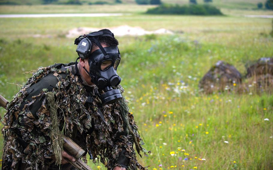 A French sniper exits a tear-gas filled trench wearing a gas mask during the eighth annual European Best Sniper Team Competition on Aug. 8, 2024, at the Joint Multinational Readiness Center in Hohenfels, Germany.