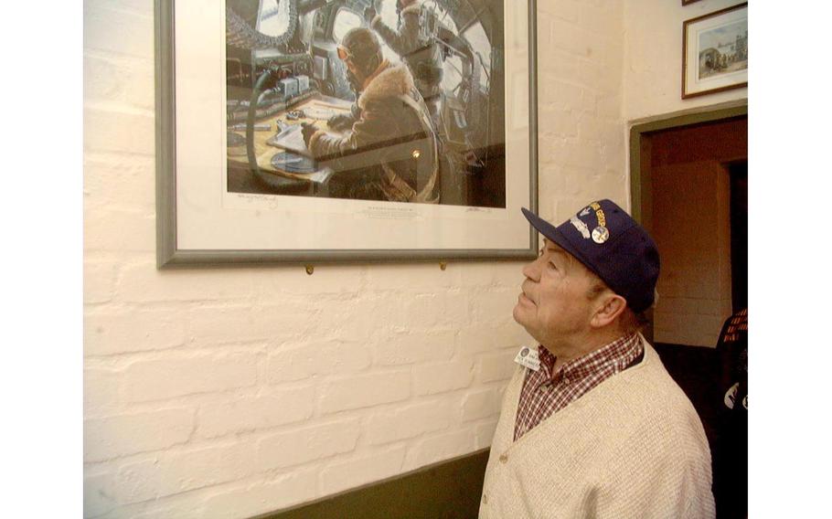 Ken Summers examines a painting hanging in the 100th Bomb Group Memorial Museum at Thorpe Abbots, England, site of the unit's airfield during World War II. Summers was a bombardier in the unit. The museum is in the airfield's old control tower.