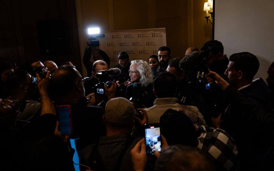 Reporters, microphones and cameras surround Debra Tice.