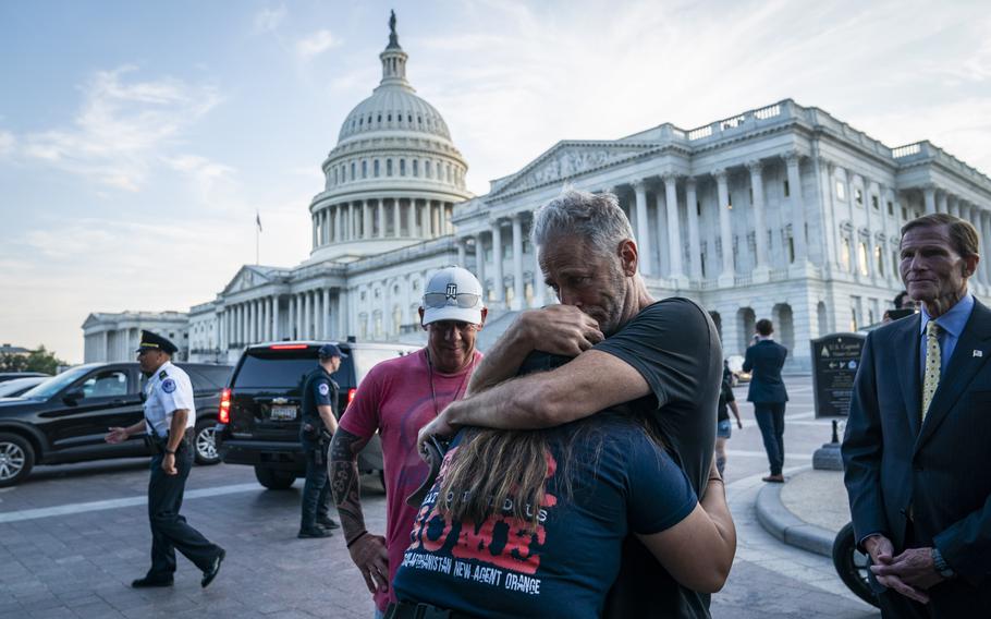 Comedian and activist Jon Stewart hugs Rosie Torres, wife of veteran Le Roy Torres, as they celebrate Senate passage in August 2022 of the PACT Act, major legislation to compensate veterans for toxic exposures. 