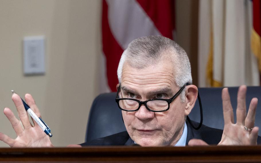 Rep. Matt Rosendale raises his hands and talks during a House hearing.