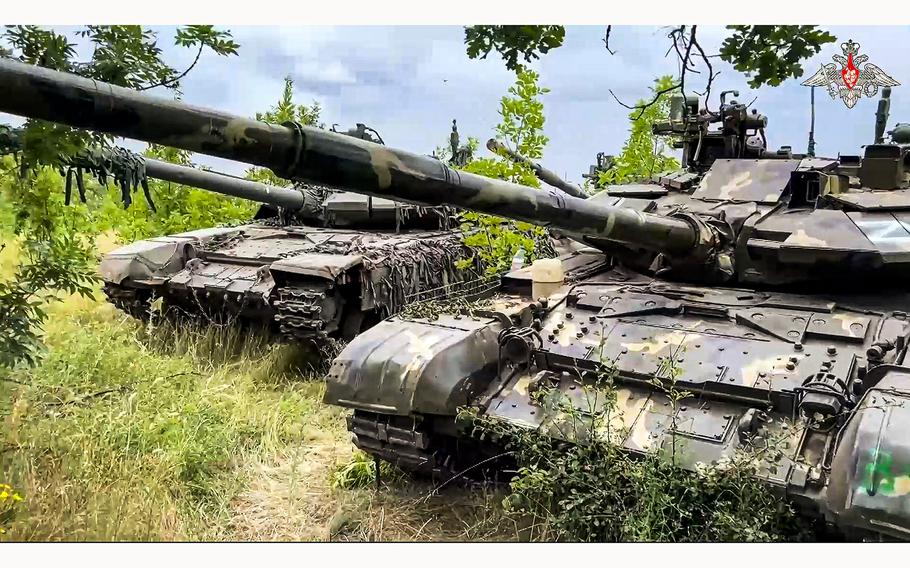 Tanks belonging to Russia’s Wagner military contractor are parked ahead of their handover to the Russian military at an undisclosed location.
