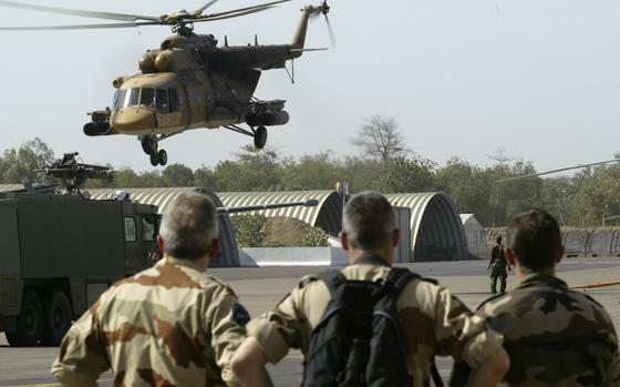 FILE - French troops watch a Chadian air force helicopter take off from N'Djamena, Chad, Wednesday Feb. 6, 2008. (AP Photo/Jerome Delay, File)