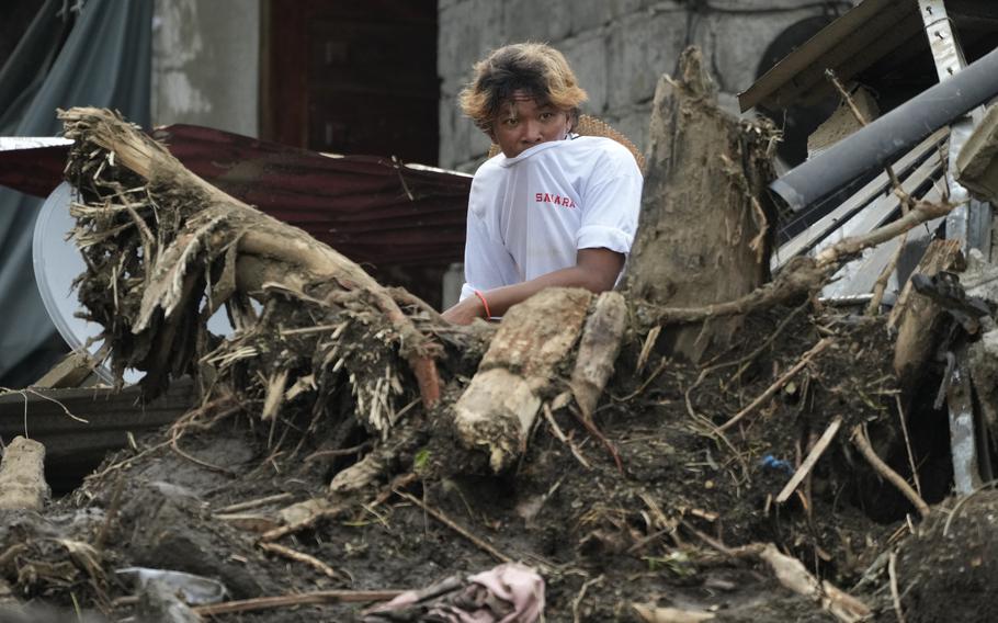 A villager watches relief operations after a recent landslide triggered by tropical storm Trami hit Talisay, Batangas province, Philippines, leaving thousands homeless and several villagers dead on Saturday, October 26, 2024 . 