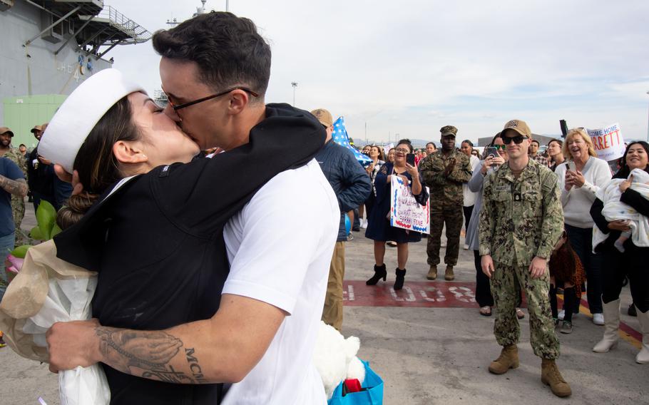 A sailor kisses her significant other