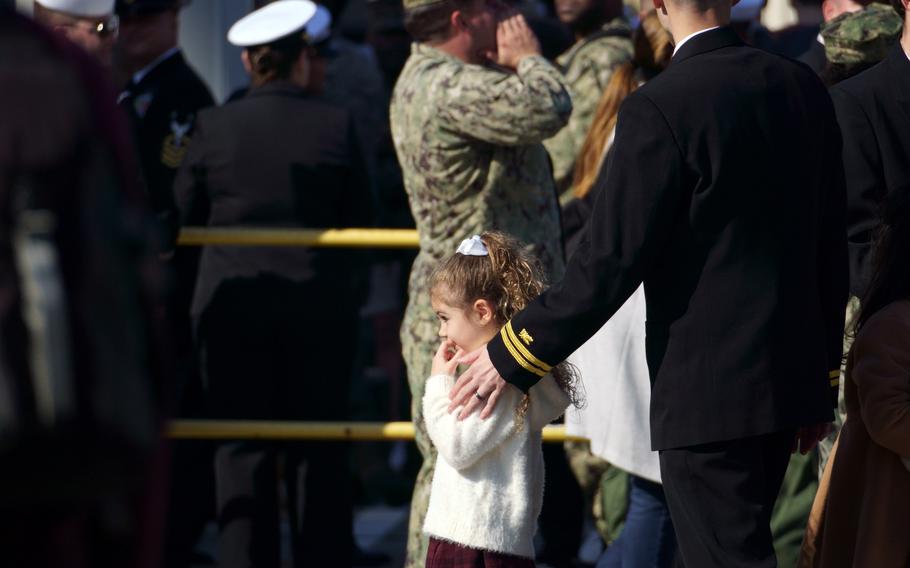 Family members and friends wait pierside as the aircraft carrier USS George Washington arrives at Yokosuka Naval Base, Japan. Nov. 22, 2024.