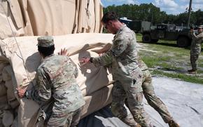 Soldiers from the 256th Medical Company Area Support (256th MCAS) secure their equipment after inspection, in preparation of Hurricane Helene, Sep. 24, 2024.