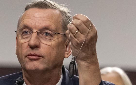 VA Secretary nominee Doug Collins holds up his dogtags on Tuesday, Jan. 21, 2025 during his confirmation hearing at the U.S. Senate Committee on Veteran Affairs in Washington. Eric Kayne/Stars and Stripes)