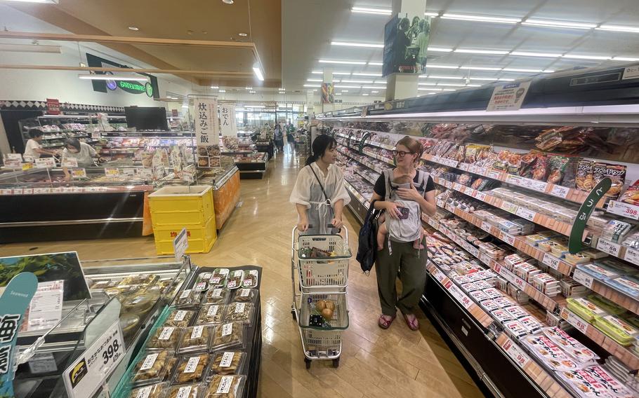 Akemi Kikugawa of the Japanese American Society helps Marine Corps spouse Camille Williamson shop at a Japanese grocery store near Marine Corps Air Station Iwakuni, Japan, Sept. 17, 2024.