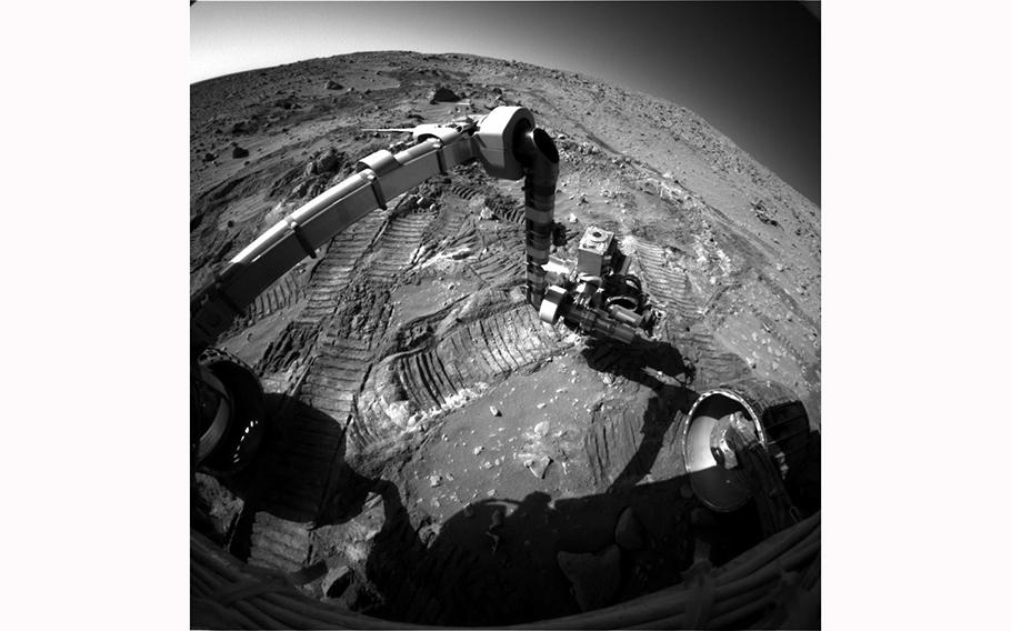 An image of the rover Spirit in operation on the surface of Mars. 