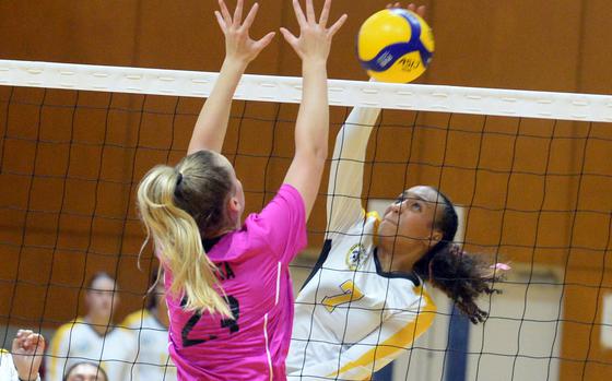 Kadena's Ananda McCoy spikes against Yokota's Claire Smith on Day 1 of the 10th ASIJ YUJO Tournament. Kadena won in three sets.