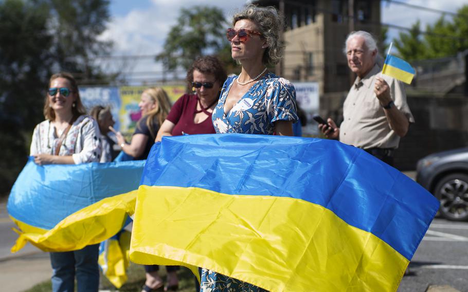 Kristina Ramanauskas, a first generation Lithuanian, waves a Ukrainian flag 