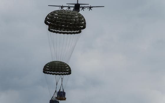 An Air Force C-130J Super Hercules drops pallets of water drums near Yeoju city, South Korea, during a training exercise, June 25, 2024. 