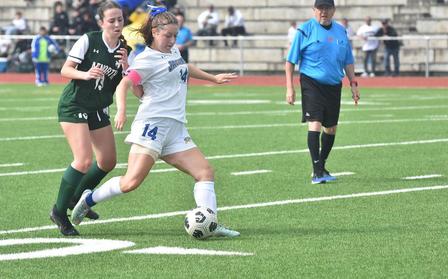 In spite of the efforts of AFNORTH's Blanca Briz Susin, Sigonella's Isabelle Belezza got a shot off. But the Jaguars couldn't get the ball in goal in a 2-0 victory by the Lions in the DODEA European Division III girls soccer tournament at Ramstein High School in Germany.