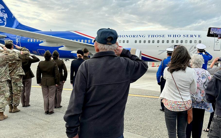 Gerald McAllister, 91, salutes a plane at Seattle-Tacoma International Airport, Aug. 15, 2024, bringing home the remains of his great uncle, Pfc. Charles McAllister, who was killed during World War I and remained missing for more than a century.