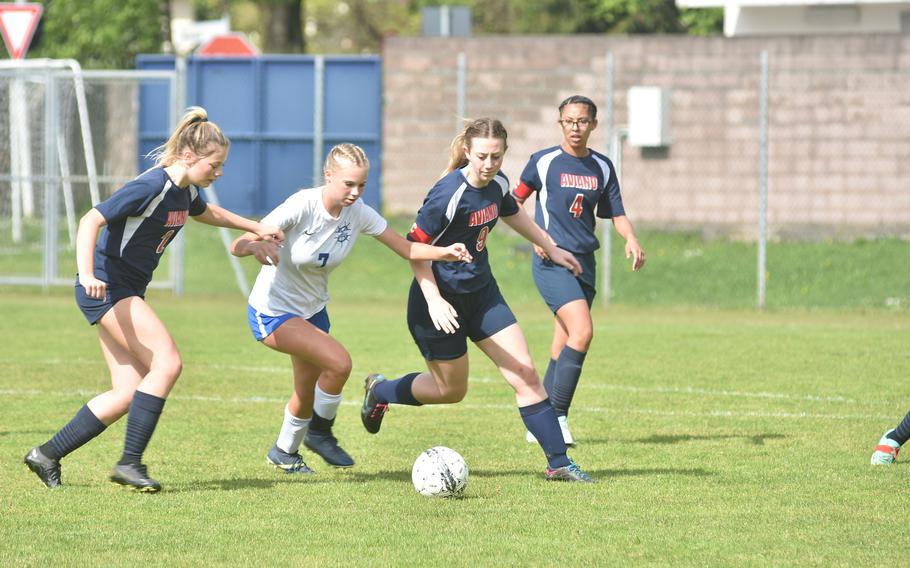 Rota freshman Gracelyn Markowski tries to maintain control while defended by Aviano’s Lydia Plunkett, left, and Mayci Salmon in the Admirals’ 3-0 victory over the Saints on Saturday, April 27, 2024.