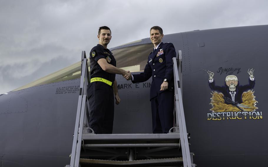 Air Force Col. Mark Kimball, pictured on the right, takes command of the 28th Operations Group on June 9, 2023, at Ellsworth Air Force Base, S.D. Kimball is shaking the hand of Staff Sgt. Jacob Szatkowski, the 28th Aircraft Maintenance Squadron dedicated crew chief.