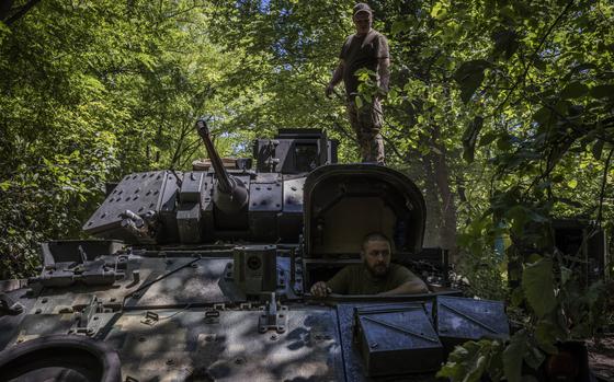 Soldiers and mechanics from Ukraine’s 47th Mechanized Brigade test-drive a U.S.-made Bradley Fighting Vehicle in a wooded area in Ukraine's Zaporizhzhia region on July 13, 2023. MUST CREDIT: Ed Ram for The Washington Post