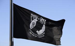 The National League of POW/MIA Families flag flies over an Air Force base in 2014.