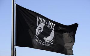 The National League of POW/MIA Families flag flies over an Air Force base in 2014.