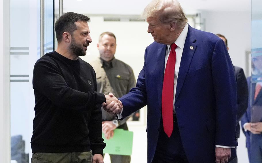 Donald Trump shaking hands with Volodymyr Zelenskyy.