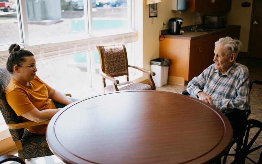 West Virginia University greenhouse manager Whitney Dudding chats with plant pathology Professor Emeritus Mannon Gallegly, 101. Earlier that morning Dudding had led a group at the WVU Organic Farm in Morgantown, W.Va., planting varieties of tomatoes Gallegly developed that would be harvested for seed distribution. 